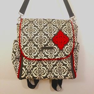 Petunia Picklebottom, black and white patterned diaper bag with red embroidery.